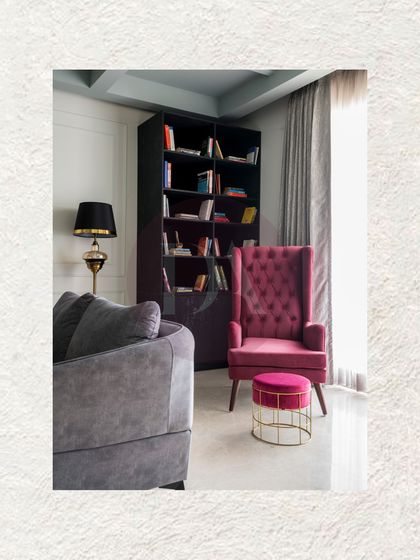 Every living room needs a cozy corner for quiet moments. We created this reading nook with a comfortable magenta wingback chair and a sleek bookshelf, showing how even small areas can be designed with purpose and style.
