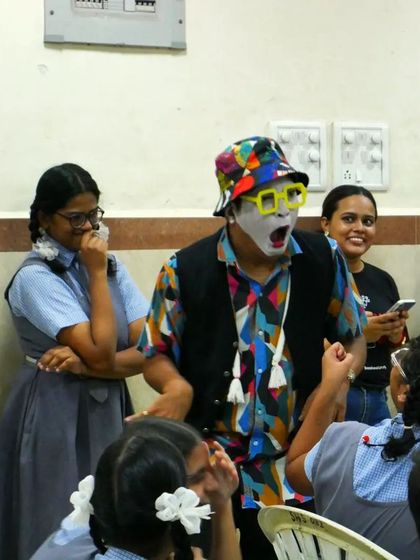The 'Silent Storyteller' captivates his audience with expressive gestures. The reactions of the children and volunteers show the universal power of a well-told story, even without words.