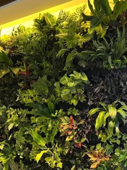 This close-up shows the detail of our "jungle theme" artificial green wall. We use a variety of high-quality, realistic plants with different textures and shades of green to create a dense, wild, and incredibly lifelike appearance without any maintenance.