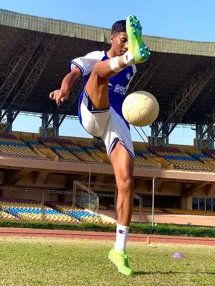 We nurture individual brilliance and skill. This shot captures BPSS player Umesh executing a high kick with perfect form and control during a training session in a professional stadium environment.