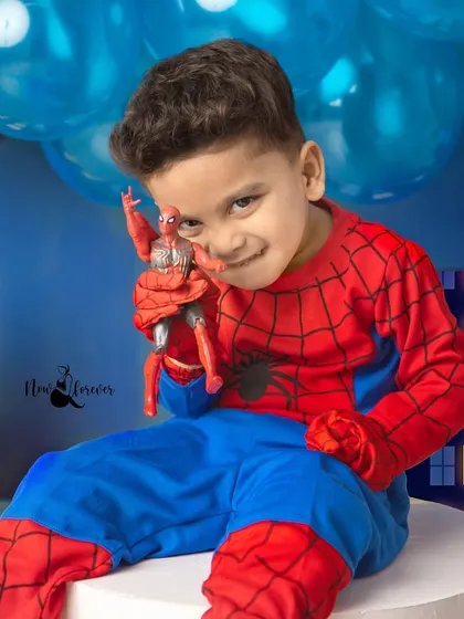 A mischievous grin from our little hero as he holds up his Spider-Man action figure. It's a fun "twin" moment that shows his love for the character.