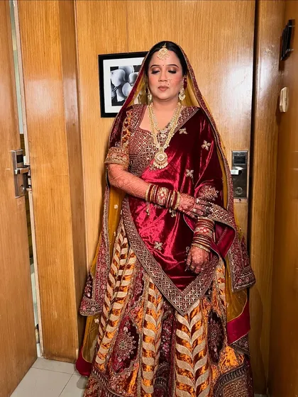 A serene portrait, with eyes closed to show the soft and subtle eye makeup that complements the heavy outfit.