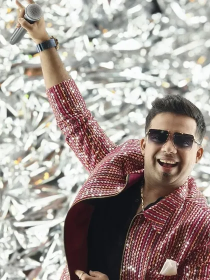 An energetic shot against a glittering silver backdrop. As an anchor, I know how to command the stage and be the center of the celebration's energy.