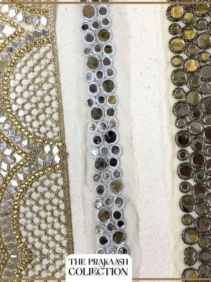 A selection of three distinct mirror work laces, ranging from traditional gold zari and mirror designs to modern, geometric mirror patterns. These trims add a dazzling effect to sarees, kurtas, and festive outfits.