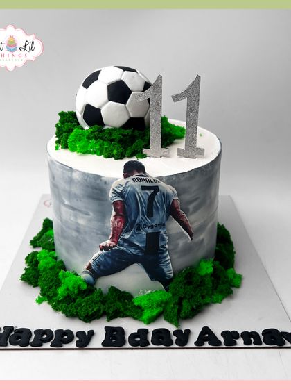 A cake for a true football fan, celebrating Arnav's 11th birthday with a Ronaldo theme, complete with the player's iconic celebration pose.