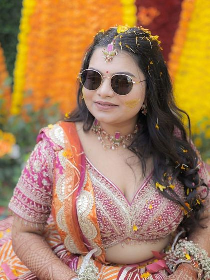 A close-up of the Haldi bride. Her makeup is minimal, with a focus on clean skin and defined eyes, allowing her natural beauty to shine.