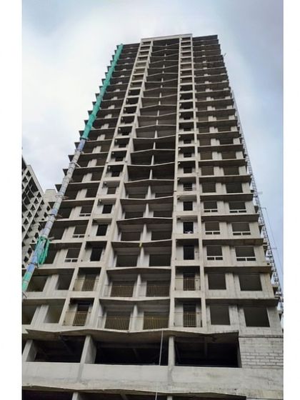 A residential tower in North Mumbai during its construction. This image provides a clear view of the concrete structure, showing the raw form of the building before the finishing touches and façade are added.