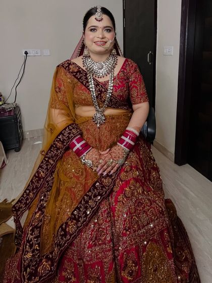 A full-length portrait of the bride, looking regal and elegant in her stunning outfit.