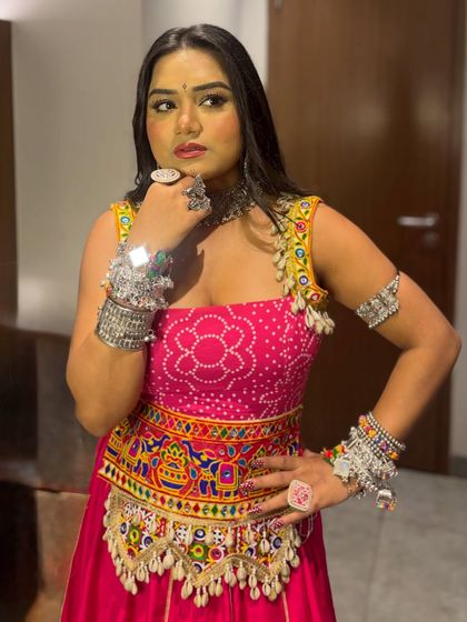 A posed shot in my colorful Navratri outfit. The combination of a pink bandhani top with a multi-colored embroidered kedia jacket is perfect for a night of dance.