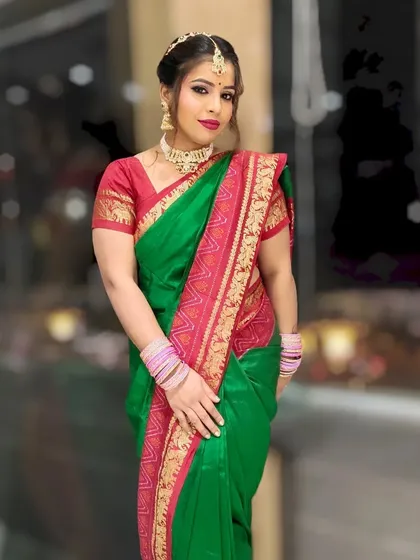 A full-length view of the South Indian inspired look, complete with traditional jewelry and a radiant smile.