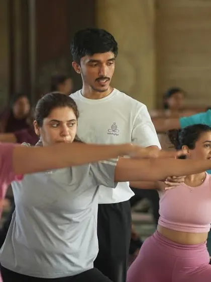 Here in our shala, you are never just a face in the crowd. This is what our practice looks like: a shared space where the energy of the group lifts you, while personal guidance from our teachers ensures your alignment and safety. We are here to help you find your strength in poses like Virabhadrasana II, the warrior pose.