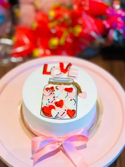 My Valentine's bento cakes are perfect for a celebration for two. This one features a hand-painted 'jar of hearts' design and is tied with a delicate pink ribbon.