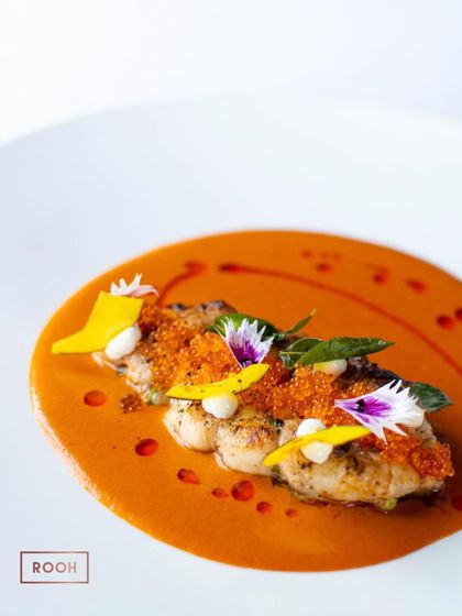 The Goan Prawn Curry, a harmonious blend of sweet, sour, and spicy notes. The edible flowers and mango slivers add a touch of elegance and freshness to this coastal classic.