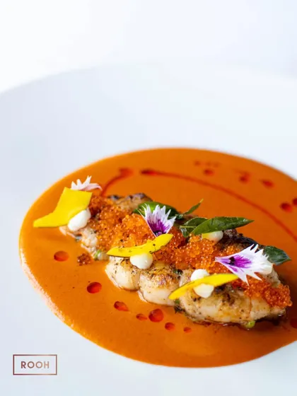 The Goan Prawn Curry, a harmonious blend of sweet, sour, and spicy notes. The edible flowers and mango slivers add a touch of elegance and freshness to this coastal classic.
