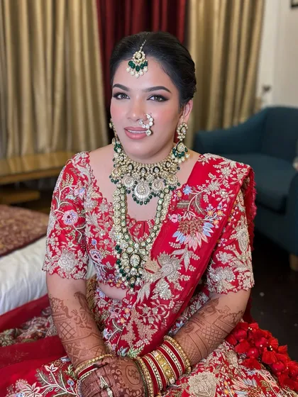 A full portrait of Vibhuti's stunning bridal look. The makeup was designed to balance her heavy jewelry and outfit, creating a cohesive and royal appearance.