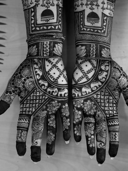 A black and white version of the intricate bridal mehendi, emphasizing the patterns and textures of the design.