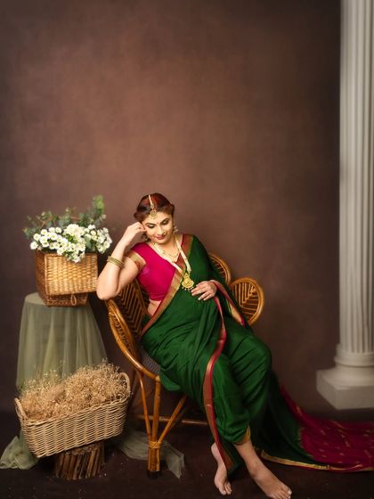 A contemplative moment captured in the studio. The classic pillar and floral arrangements add a touch of grandeur to this traditional maternity portrait.