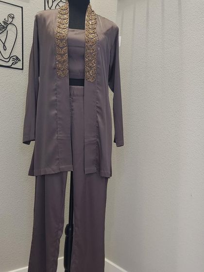 This three-piece fusion set includes a crop top, straight-leg pants, and a longline jacket with beautiful embroidery along the lapels. It's a sophisticated and modern take on ethnic wear that I can customize for a perfect fit.