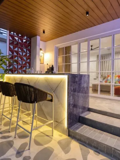 The terrace bar is illuminated with soft backlighting, creating an inviting ambiance for evening gatherings. A brick-textured wall adds another layer of detail.