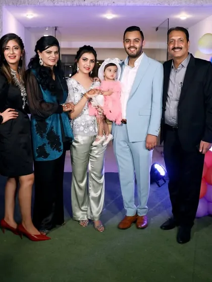 A complete family and friends group photo with the Disney mascots, capturing everyone who came to celebrate the little one's big day.