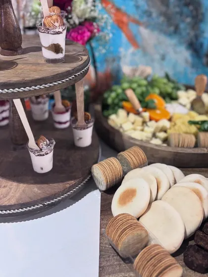 A close-up of individual dessert cups and other sweet treats on a tiered stand. This display was part of a larger spread for the Mulberry Nails & Lashes launch event.