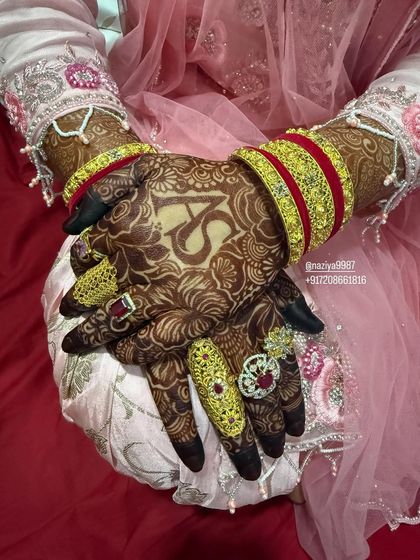 A beautiful shot of the bride's hands, featuring the couple's initials 'A' and 'S' surrounded by intricate floral work.