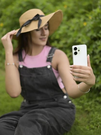 A candid selfie moment during the OPPO campaign, showing the phone's design and ease of use. It’s a natural way to feature the product while maintaining the lifestyle vibe of the shoot.