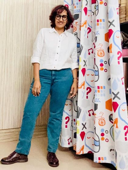 Posing next to a fun, graphic curtain in my home. I surround myself with patterns and colors.