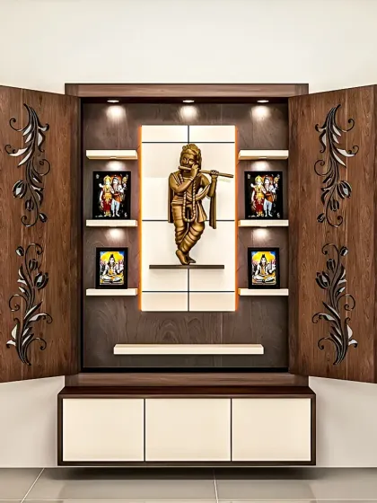 This wall-mounted pooja unit combines traditional motifs with modern design. I used intricate laser-cut wooden doors and integrated spotlights to create a serene and beautiful space for prayer that fits seamlessly into a contemporary home.