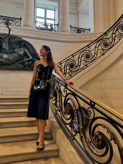 Postcards from the Louvre Museum in Paris. For this cultural outing, I wore a sophisticated navy dress with a floral appliqué bustier, paired with classic pointed-toe flats.