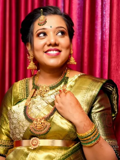 This bride chose a traditional Kempu set with a Lakshmi pendant for her wedding. The green and gold combination is a classic and auspicious choice.
