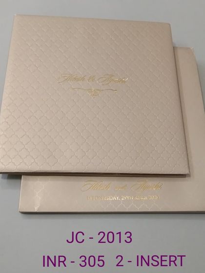 A premium and minimalist invitation with a textured, quilted pattern and simple gold foil names. This design is all about quiet luxury and sophistication.