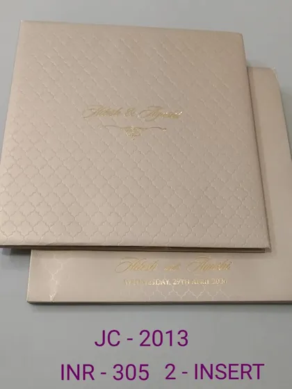 A premium and minimalist invitation with a textured, quilted pattern and simple gold foil names. This design is all about quiet luxury and sophistication.