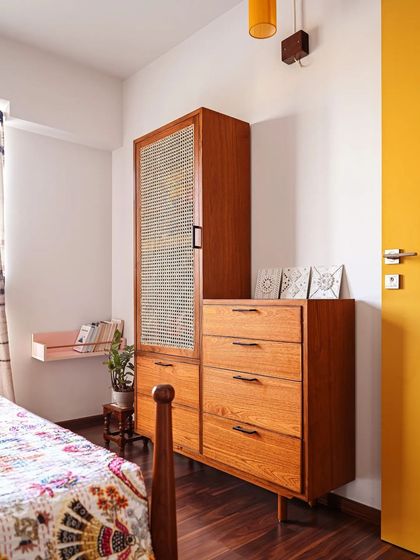 Rattan is the perfect material for airing closets as it allows for ventilation. Here, we designed custom closets integrated with a chest of drawers, providing a complete and functional storage solution for the bedroom.