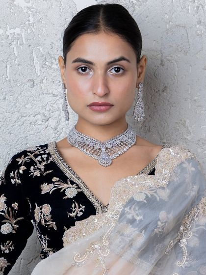 Our stunning all-diamond choker set, perfect for a glamorous reception or cocktail party. The intricate design showcases the brilliance of the American diamonds, creating a truly luxurious piece.