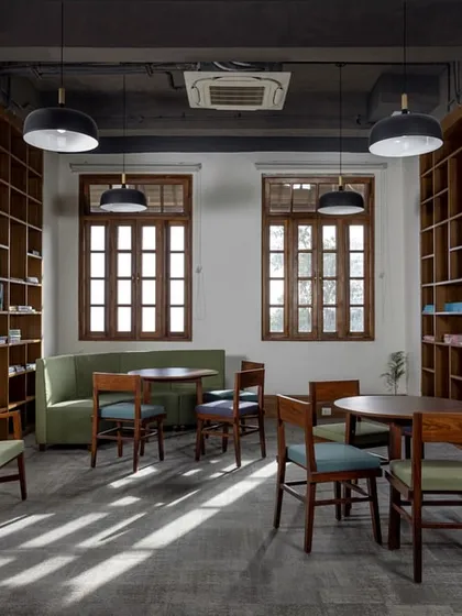 Sunlight streams into this renovated library and study area, where we restored the original windows and used natural wood tones to create a calm and studious environment.