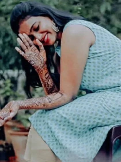 Another happy moment with Rashmi, showcasing her unique storytelling mehendi that captures her personality and love story.