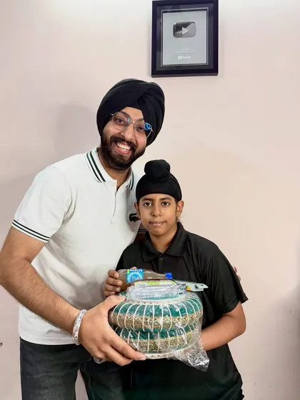 A happy moment from our student meetup. It’s a joy to reward my dedicated students for their progress and see them smile. That's the YouTube Silver Play Button in the background, all thanks to them.