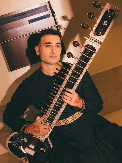 A close-up portrait with the sitar. The henna on my hands is a nod to tradition, while the overall look is modern and clean.