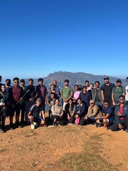 A large group photo from our Bandaje Falls trek, with the beautiful Western Ghats in the background.