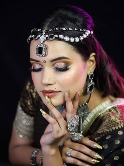 An elegant pose showcasing the full look, including the beautiful gold-threaded saree.