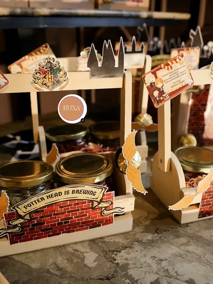 A view of the Harry Potter themed favors set up on a rustic wooden table, ready for the party.