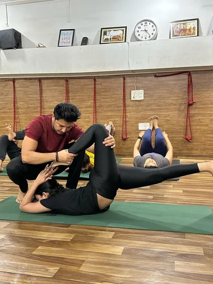 I provide precise, hands-on adjustments to help students find correct alignment in complex poses, ensuring a safe and effective practice that deepens their understanding of the asana.