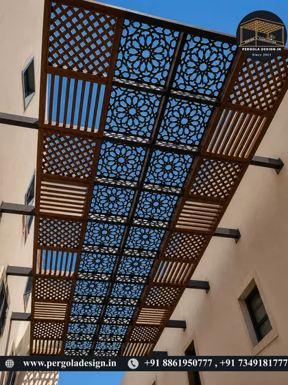 A view looking up at a custom-fabricated carport ceiling. We used a mix of different laser-cut patterns, including geometric and lattice designs, to create a visually dynamic and textured roof. This approach provides partial shade while adding significant artistic flair.