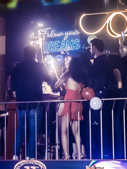 A birthday celebration in full swing with sparklers and cake.