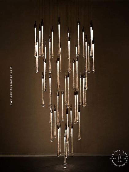 A slightly different angle of the crystal droplet chandelier, showing how the light catches the bubbles within the glass rods, adding sparkle and life to the fixture.