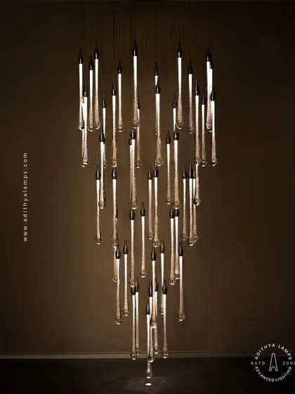 A slightly different angle of the crystal droplet chandelier, showing how the light catches the bubbles within the glass rods, adding sparkle and life to the fixture.