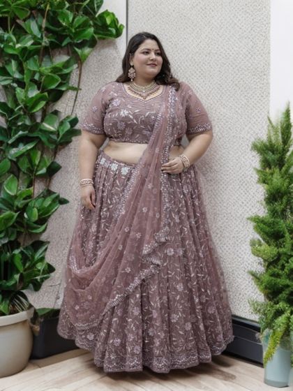 This image shows the beautiful drape of the dupatta and the intricate floral embroidery on this plus-size lehenga. It’s a perfect blend of comfort and high-end style.