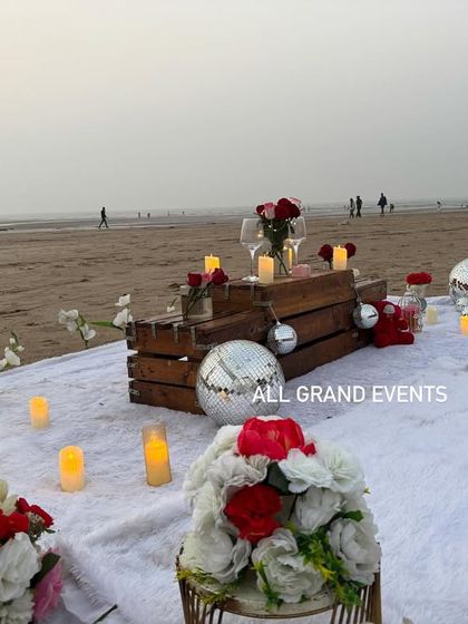 Another angle of the daytime beach proposal decor, featuring birdcage details and floral arrangements. This setup is perfect for a sunset proposal, offering great photo opportunities in natural light.
