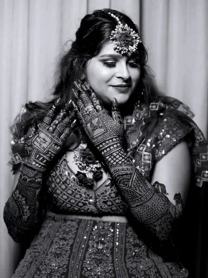 A timeless black and white portrait of the bride. This style emphasizes the emotion and the intricate patterns of her Mehndi.